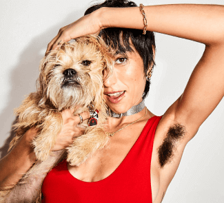 woman holding up dog and showing underarm hair