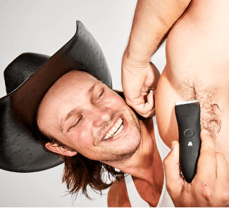 hat wearing man using Meridian trimmer to groom underarm hair