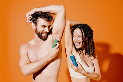 man and woman using personal trimmers to groom underarm hair