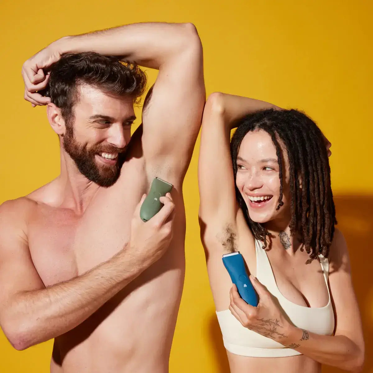 man and woman using body groomer to trim underpit hair