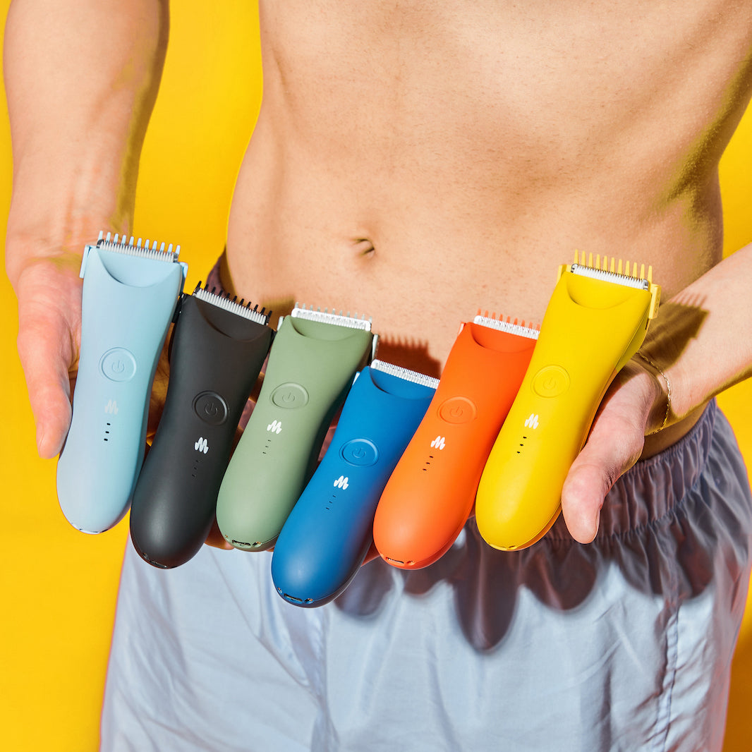Man holding 6 trimmers of different colors